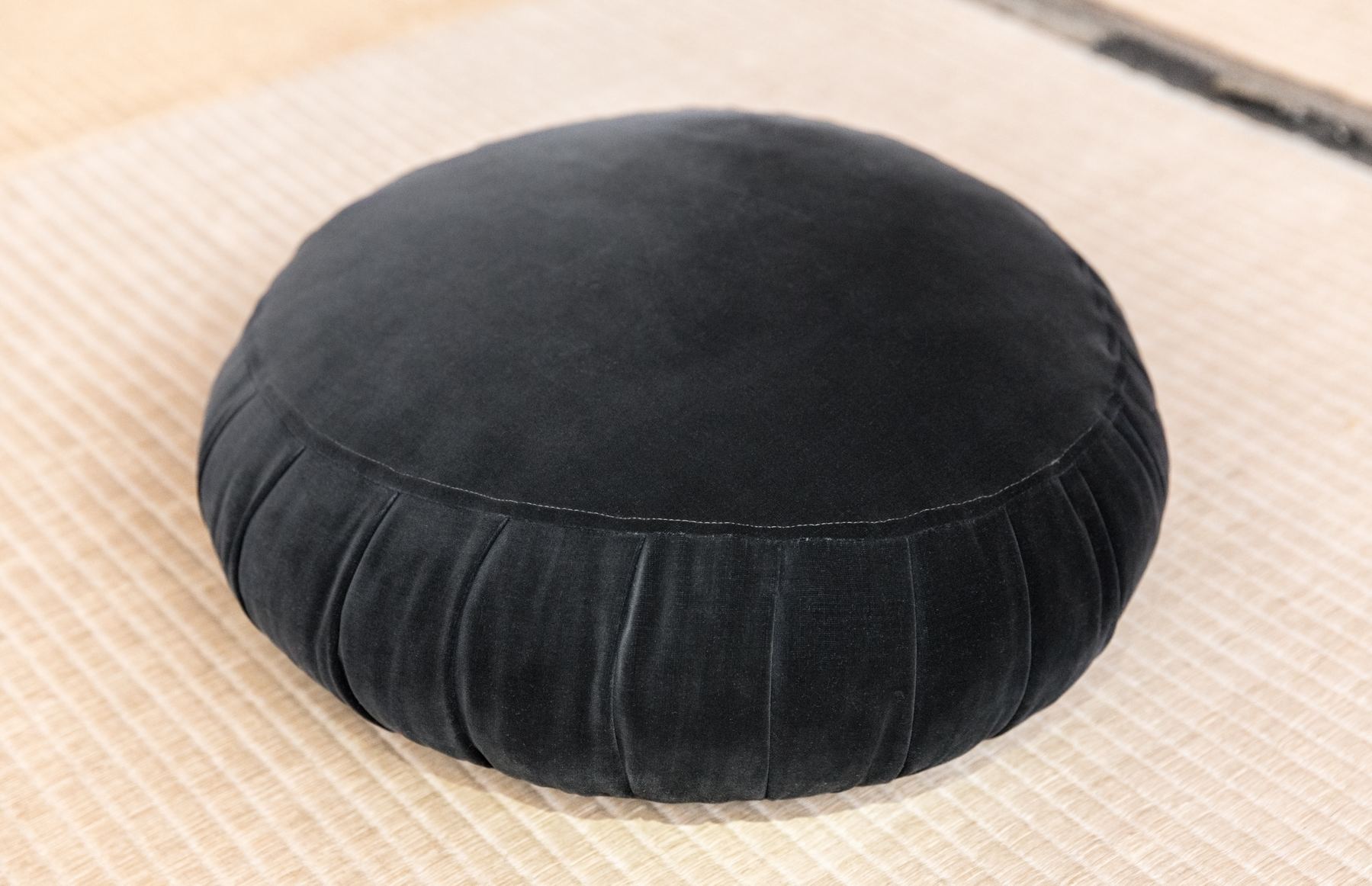 A round zafu meditation cushion, representing Yogasya's Meditation Props category